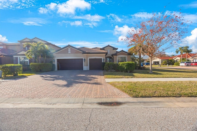 view of front of house featuring a garage and a front lawn