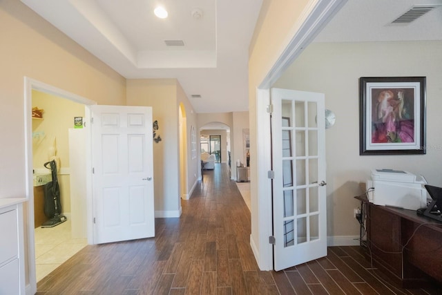 hallway with a tray ceiling