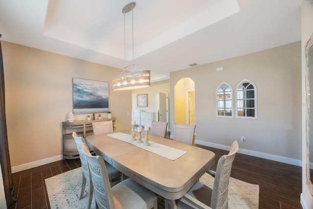 dining room with a tray ceiling