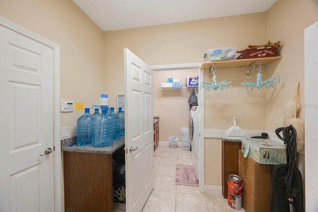 laundry room featuring washing machine and dryer and light tile patterned floors