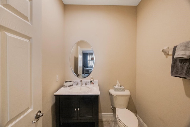 bathroom featuring vanity, tile patterned flooring, and toilet