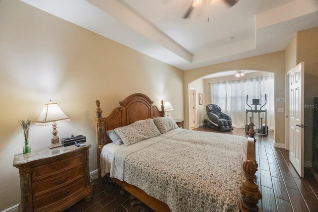 bedroom featuring a raised ceiling and ceiling fan