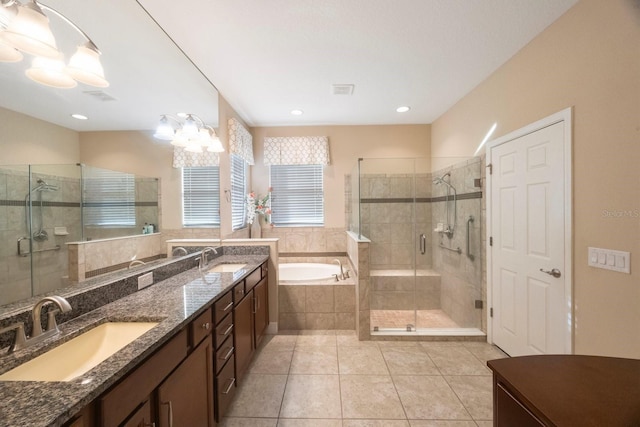 bathroom with tile patterned flooring, plus walk in shower, a notable chandelier, and vanity