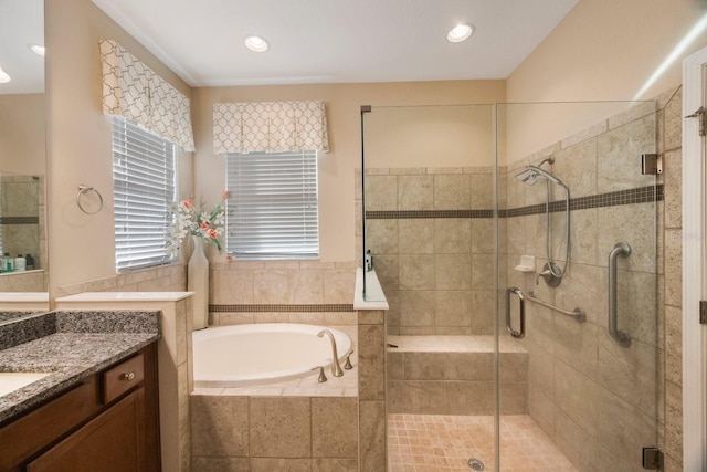 bathroom with shower with separate bathtub and vanity