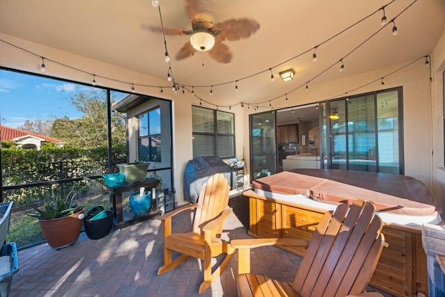 sunroom / solarium featuring ceiling fan