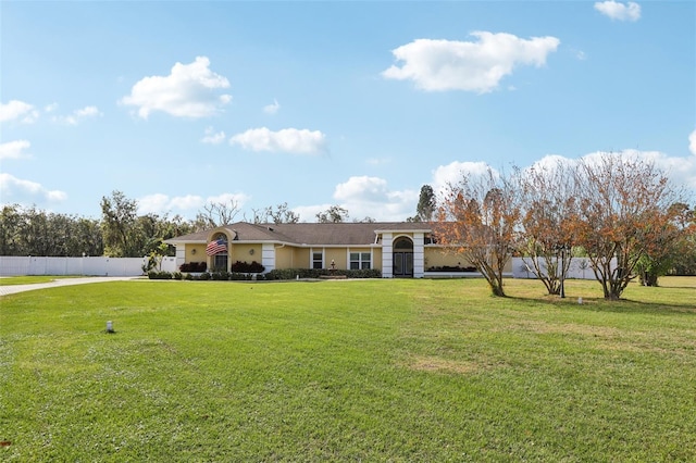 ranch-style house with a front lawn