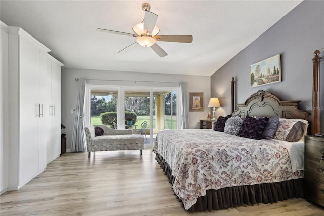 bedroom featuring lofted ceiling, ceiling fan, access to exterior, a textured ceiling, and light wood-type flooring