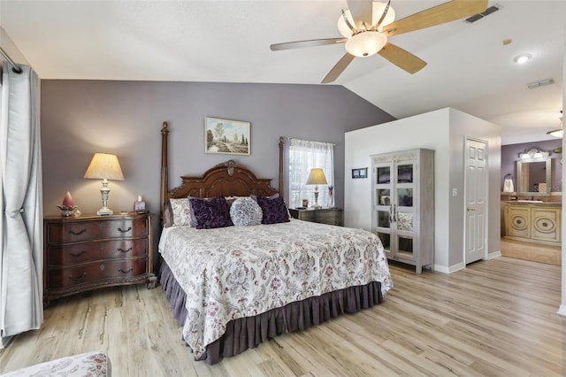 bedroom featuring vaulted ceiling, connected bathroom, ceiling fan, and light wood-type flooring