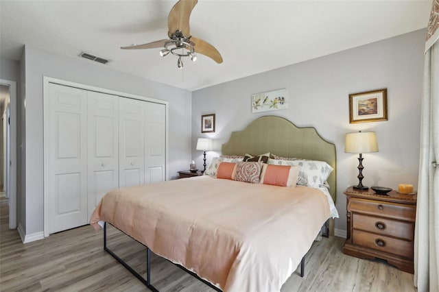 bedroom featuring ceiling fan, a closet, and light wood-type flooring