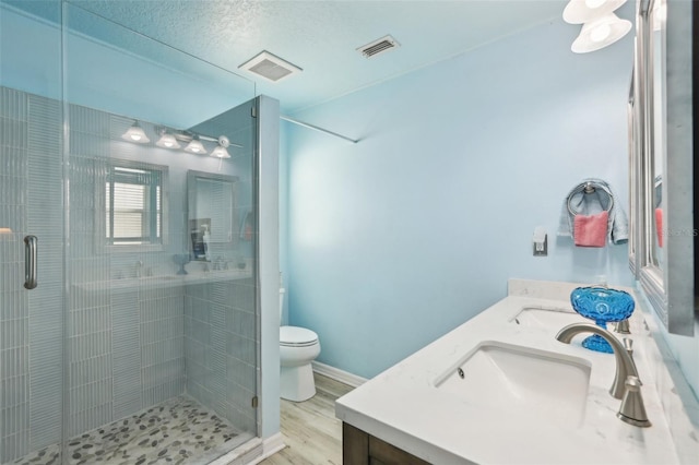 bathroom with walk in shower, vanity, toilet, and hardwood / wood-style floors