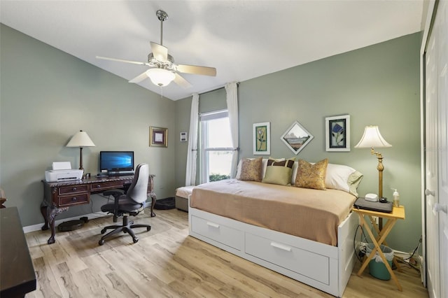 bedroom with ceiling fan, lofted ceiling, and light hardwood / wood-style floors