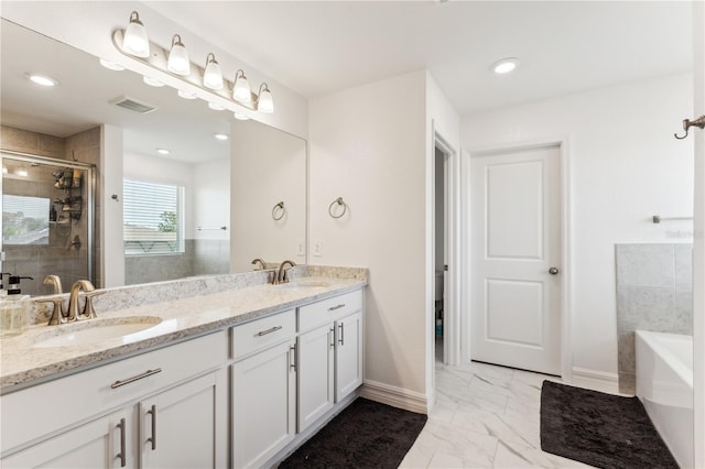 bathroom with vanity and shower with separate bathtub