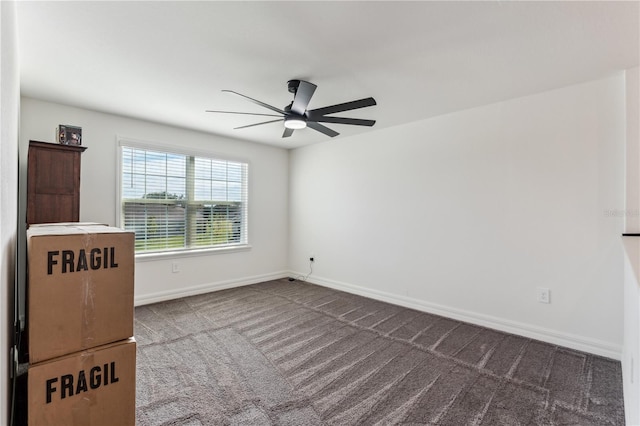 unfurnished room featuring ceiling fan and carpet