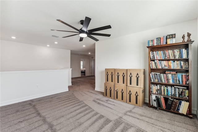 carpeted empty room featuring ceiling fan