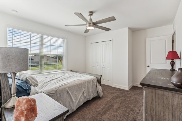 bedroom with a closet, ceiling fan, and dark colored carpet