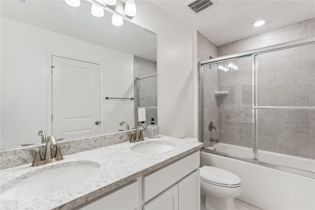 full bathroom with vanity, combined bath / shower with glass door, and toilet