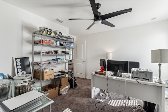 carpeted office space with ceiling fan