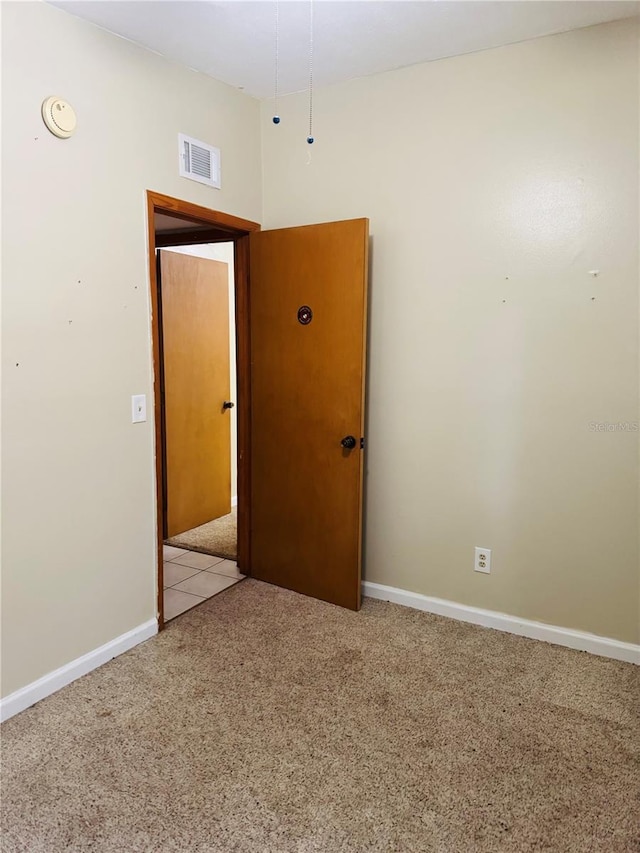 spare room with light colored carpet