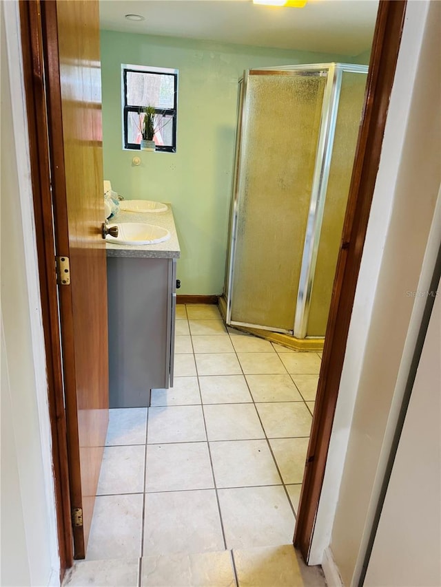 bathroom featuring vanity, tile patterned floors, and walk in shower