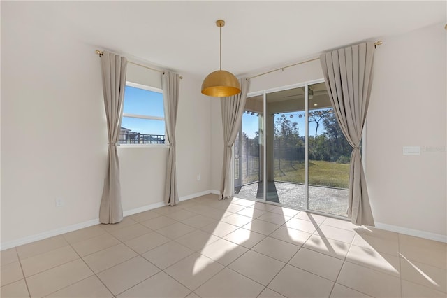 unfurnished room featuring a wealth of natural light and light tile patterned floors