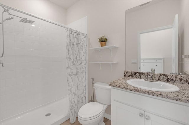 bathroom featuring vanity, a shower with shower curtain, and toilet