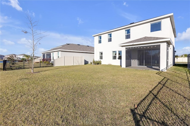 rear view of house with a yard