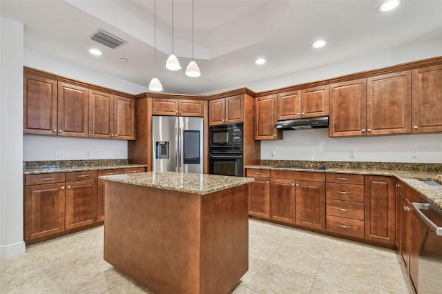 kitchen with a raised ceiling, a kitchen island, pendant lighting, light stone countertops, and black appliances