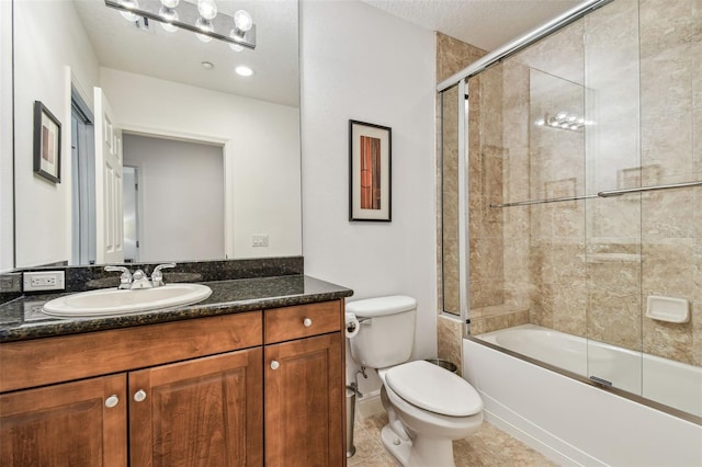 full bathroom featuring tile patterned flooring, vanity, combined bath / shower with glass door, and toilet