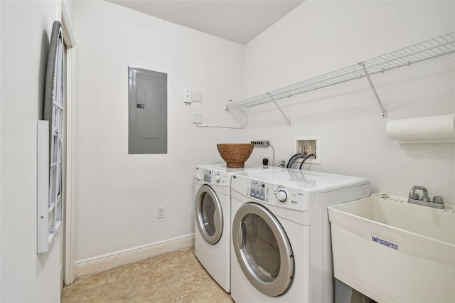 washroom featuring separate washer and dryer, sink, and electric panel