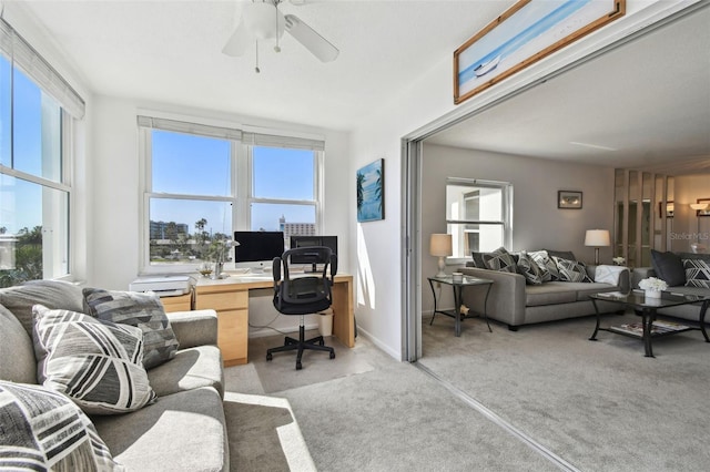 interior space with ceiling fan and light colored carpet