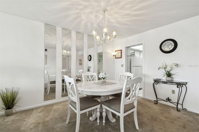 carpeted dining area featuring an inviting chandelier