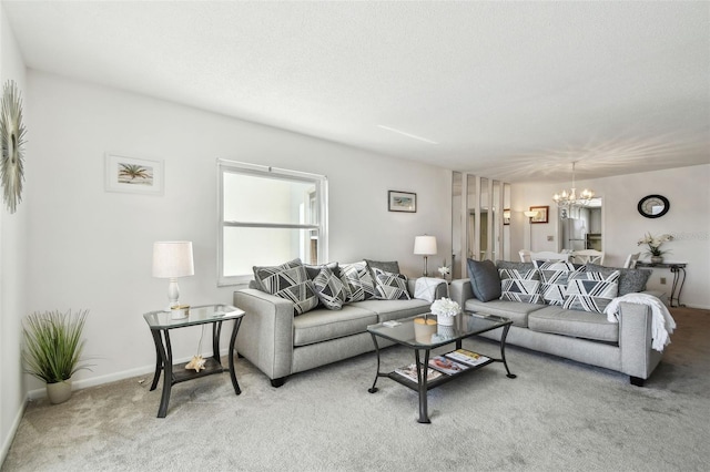 living room featuring light colored carpet, a chandelier, and a textured ceiling