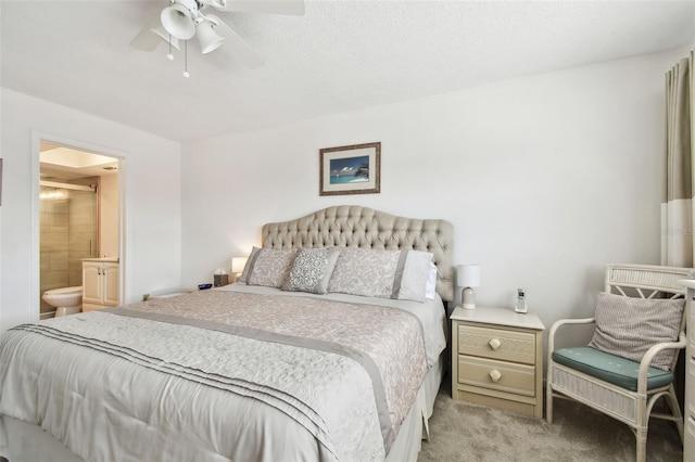 carpeted bedroom with ceiling fan and ensuite bathroom