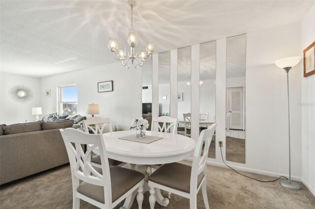 dining area featuring light carpet and a notable chandelier