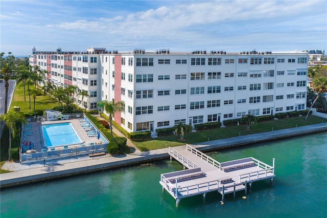 birds eye view of property featuring a water view and a community pool