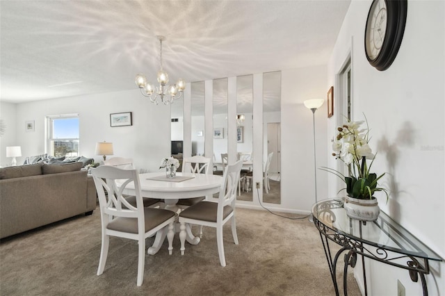 dining area with carpet flooring and a chandelier