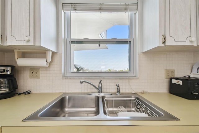 kitchen featuring tasteful backsplash and sink