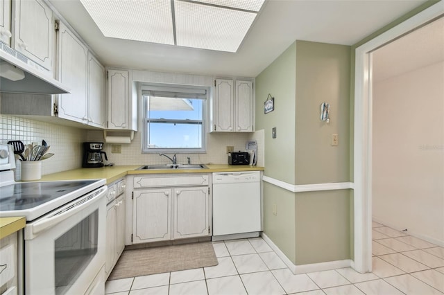 kitchen featuring tasteful backsplash, white appliances, sink, and white cabinets