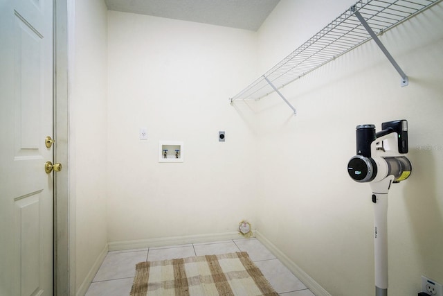 laundry area featuring light tile patterned floors, hookup for a washing machine, and hookup for an electric dryer