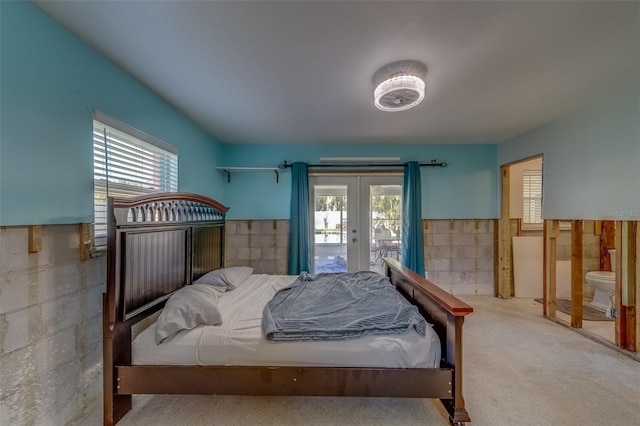 carpeted bedroom featuring access to outside and french doors