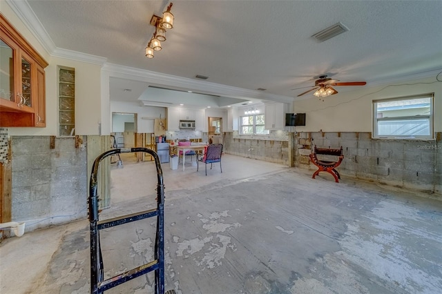 interior space with crown molding and a textured ceiling