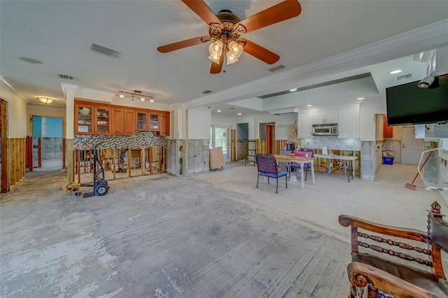 interior space with ornamental molding and a textured ceiling