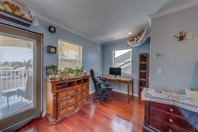 office area with hardwood / wood-style flooring and crown molding