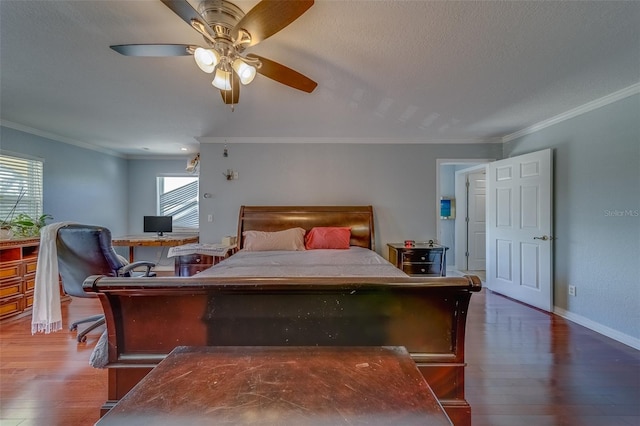 bedroom with dark hardwood / wood-style flooring, ceiling fan, ornamental molding, and a textured ceiling