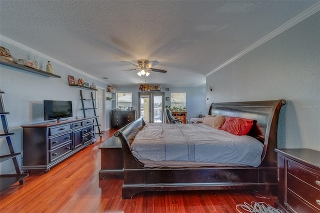 bedroom featuring crown molding, hardwood / wood-style flooring, access to outside, and a textured ceiling