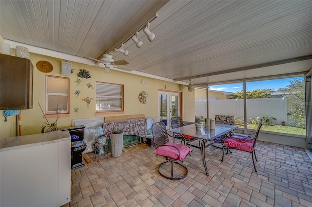 sunroom / solarium featuring french doors, ceiling fan, and rail lighting