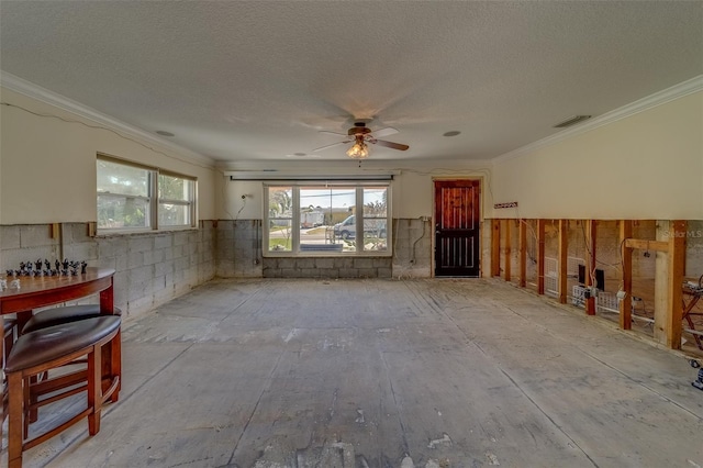 living room featuring crown molding, ceiling fan, and a textured ceiling