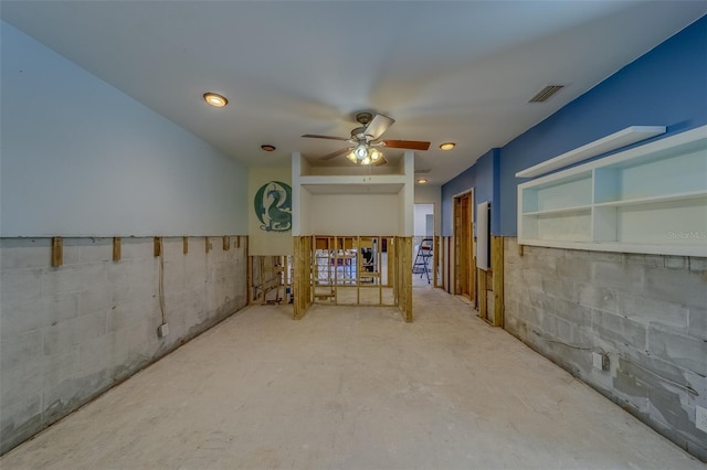 interior space with ceiling fan