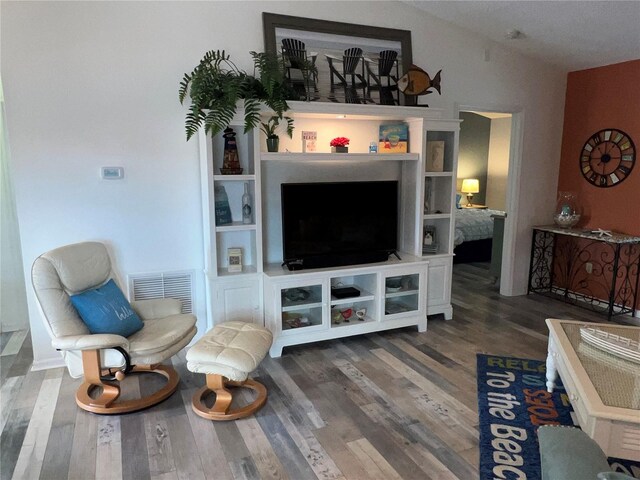 living room with dark wood-type flooring and lofted ceiling