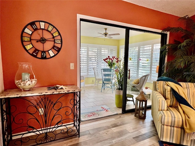 doorway to outside featuring ceiling fan and light wood-type flooring